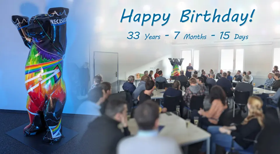 Celebration of the 33rd anniversary with a colorfully painted Berlin bear and assembled employees.